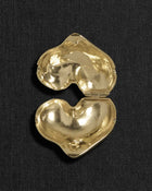 Heart-shaped 18K gold pendant on a black background