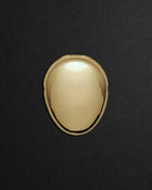 Pebble-shaped 18K gold pendant on a black background