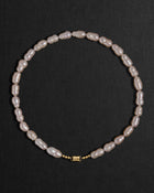 Lavender pearl necklace with a 18K gold clasp on a black background