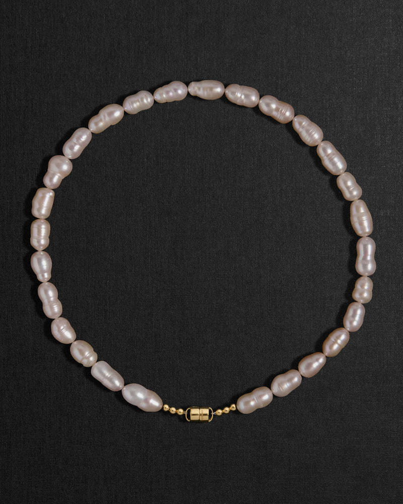 Lavender pearl necklace with a 18K gold clasp on a black background