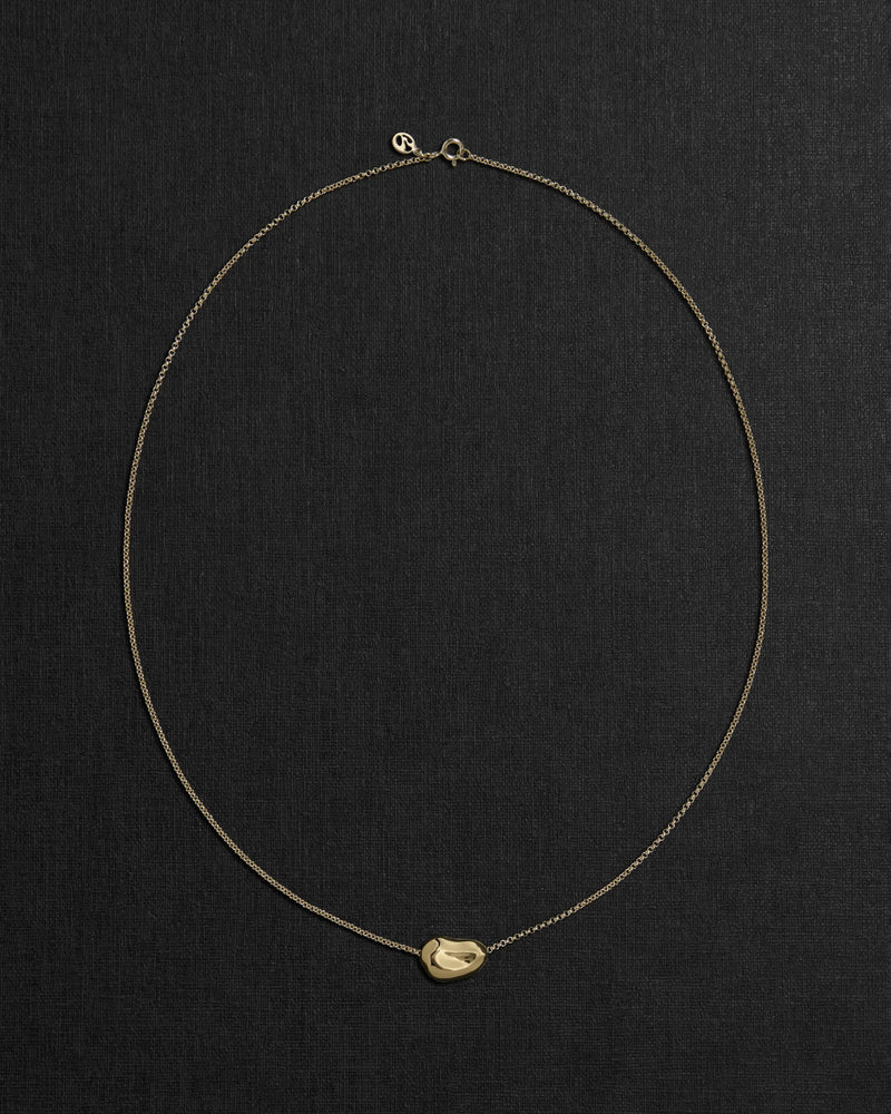 18K gold rollo chain necklace with a pomegranate-shaped pendant on a black background