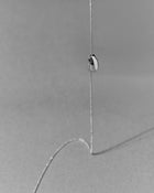 18K gold rollo chain necklace with a pomegranate-shaped pendant on a grey background