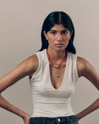 Model wearing 18K gold red cord necklace  with 18K gold pomegranate-shaped pendant and mini 18K gold pomegranate-shaped pendants