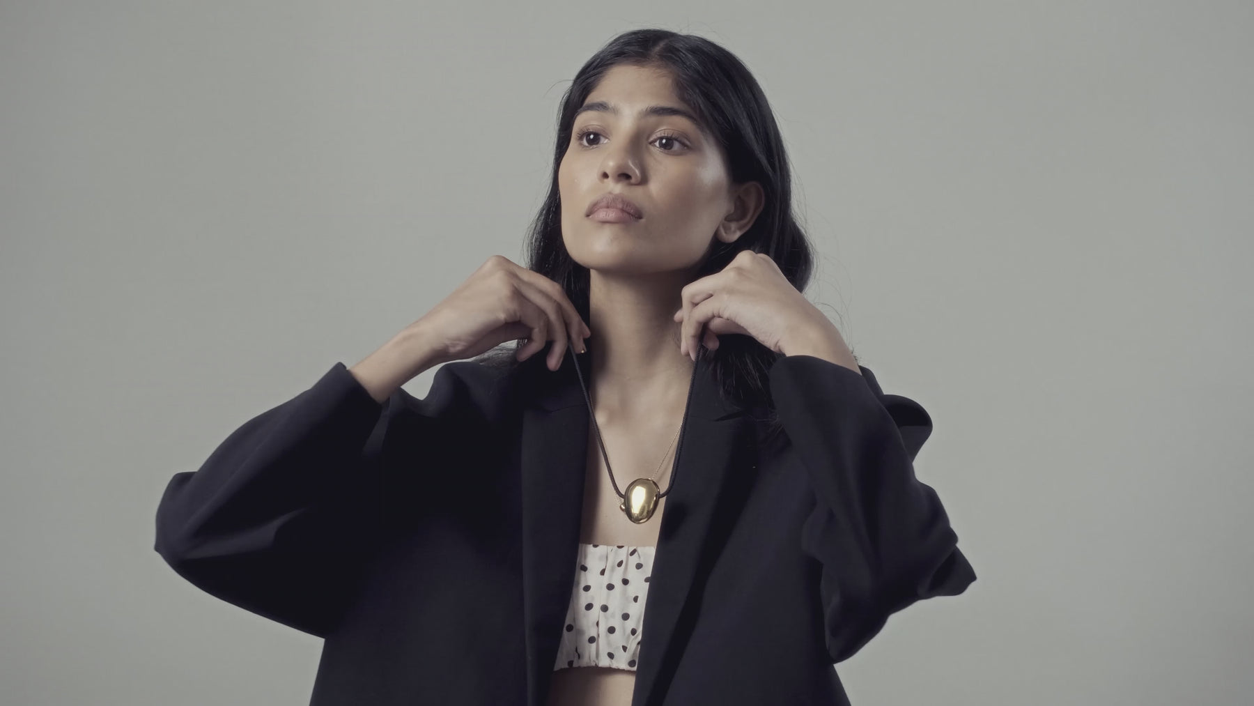 Model trying on HEROBJECTS 18K gold jewellery